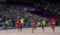 Usain Bolt of Jamaica pulls away to victory and a repeat gold medal in the Men's 100 Meter final at the 2012 London Olympics. - © Adam Stoltman. All rights reserved.