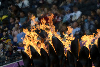 The Olympic flame with spectators at the Olympic Stadium in the background during the London Olympics  - © Adam Stoltman. All rights reserved.