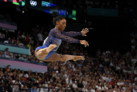 Simone Biles competing on the balance beam during the Women's All Around Gymnastics competition during the 2024 Paris Olympics, in which she took the gold medal. - © Adam Stoltman. All rights reserved.