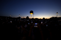 A sea of cell phones captures the rising of the Olympic flame above the Tuileries Gardens in during the Paris Olympics as thousands of people watch each night.  - © Adam Stoltman. All rights reserved.