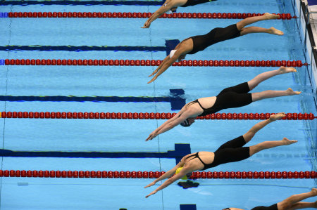 Missy Franklin of the United States, second from bottom, takes to the water at the start of the Women's 4x200 Meter Freestyle relay, in which the United States took the gold medal.